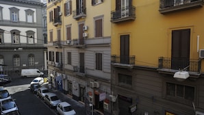 A narrow street lined with multi-story buildings, some with balconies and air conditioning units. - Jeancarlos House in the historic center (Napoli)