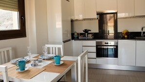 A modern kitchen with white cabinets, a stainless steel oven, and a black countertop. - Beautiful Flat in Fuengirola with terrace sea view and 2 minutes from the beach  (Fuengirola)