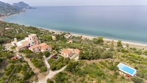 An aerial view of a coastal property with a large building, a swimming pool, and a beach. - The Tower & La Torretta by the Sea-Villa Palamara 1868 (Cefalù)