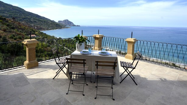 A terrace with a table set for two, overlooking a coastal landscape. - The Tower & La Torretta by the Sea-Villa Palamara 1868 (Cefalù)