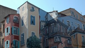 A row of colorful buildings with balconies and windows, some with shutters. - Village apartment  (Agde)