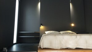 A modern bedroom with a bed, dark walls, and two wall-mounted lights. - BASKET 38+ 10m2 terrace facing the sea and Major / 4 PLACES 300mMUCEM, 800mVIEUX-PORT (Marseille)