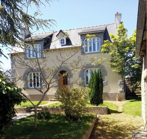 A two-story house with a garden in front.