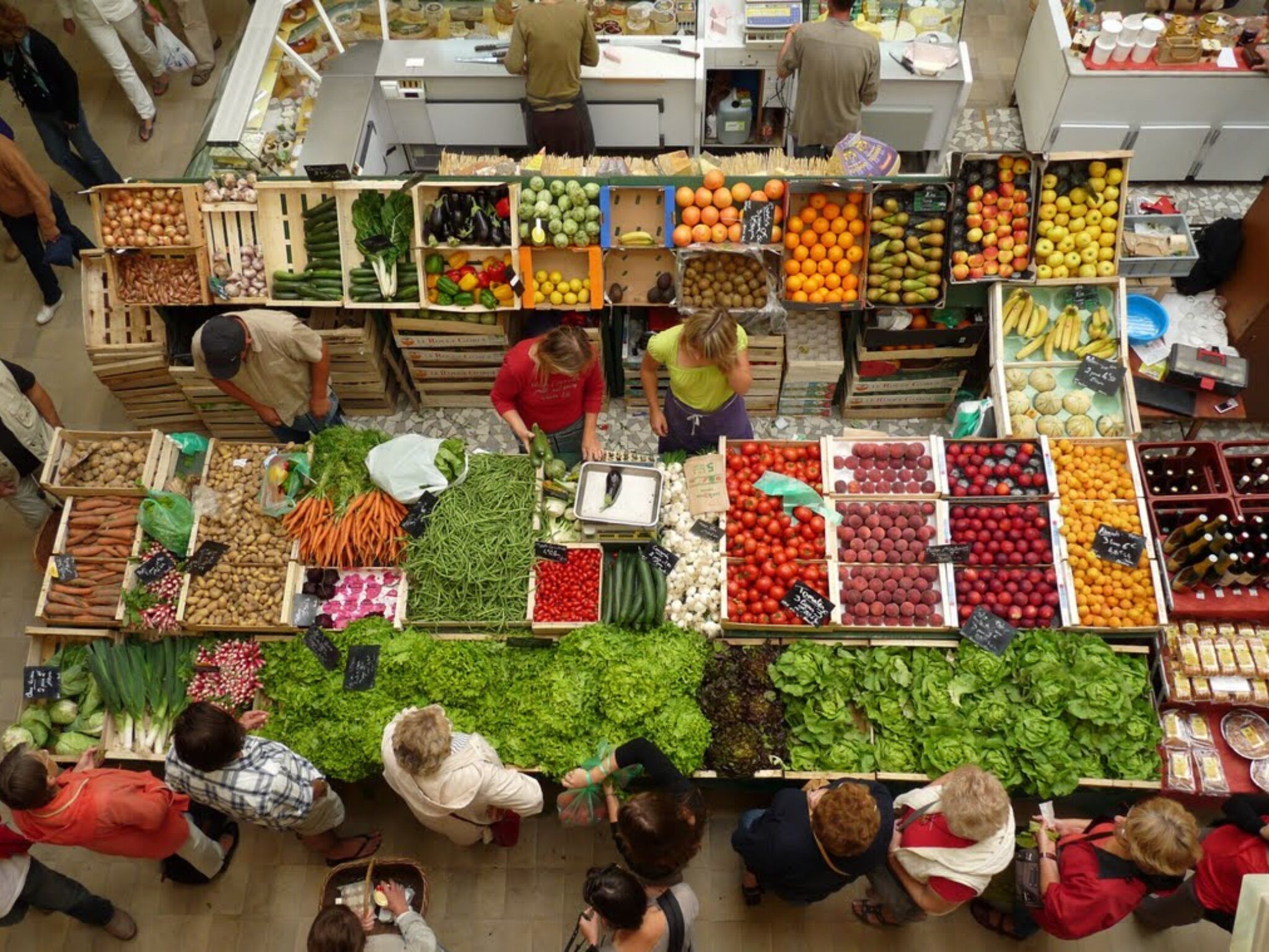 Un mercado interior con diversos productos frescos y alimentos envasados.