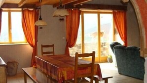 A dining area with a table and chairs, a bench, and a sofa. - Old farmhouse tastefully renovated, very good comfort, (Ardes)