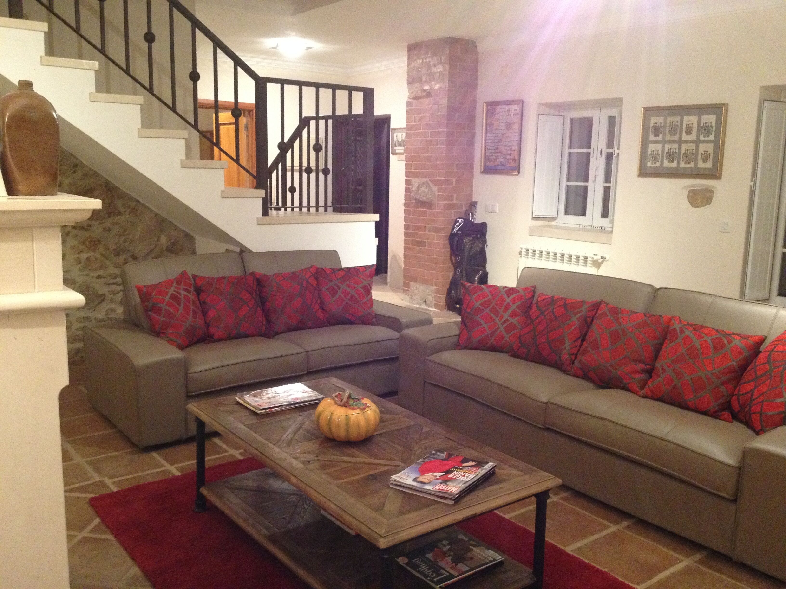 A living room with two sofas, a coffee table, and a fireplace.