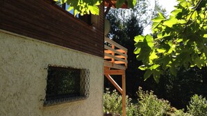 Ein rustikales Holzhaus mit Balkon und einem Fenster mit Metallgitter.