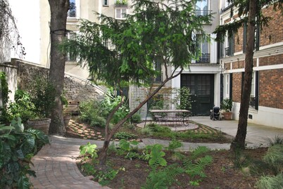 A HOUSE IN A GARDEN IN PARIS
