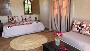 A bedroom with two beds, a sofa, a coffee table, and a window with curtains. - Marrakech Villa for 6-16 people - Exclusive Offer - 450 sq.m and 16 x 5.5 m pool (Marrakech)
