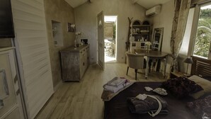 A cozy bedroom with a bed, bedside table, and a small desk area. - Detached house with summer Jacuzzi (May to early October), barbecue. (Nice)