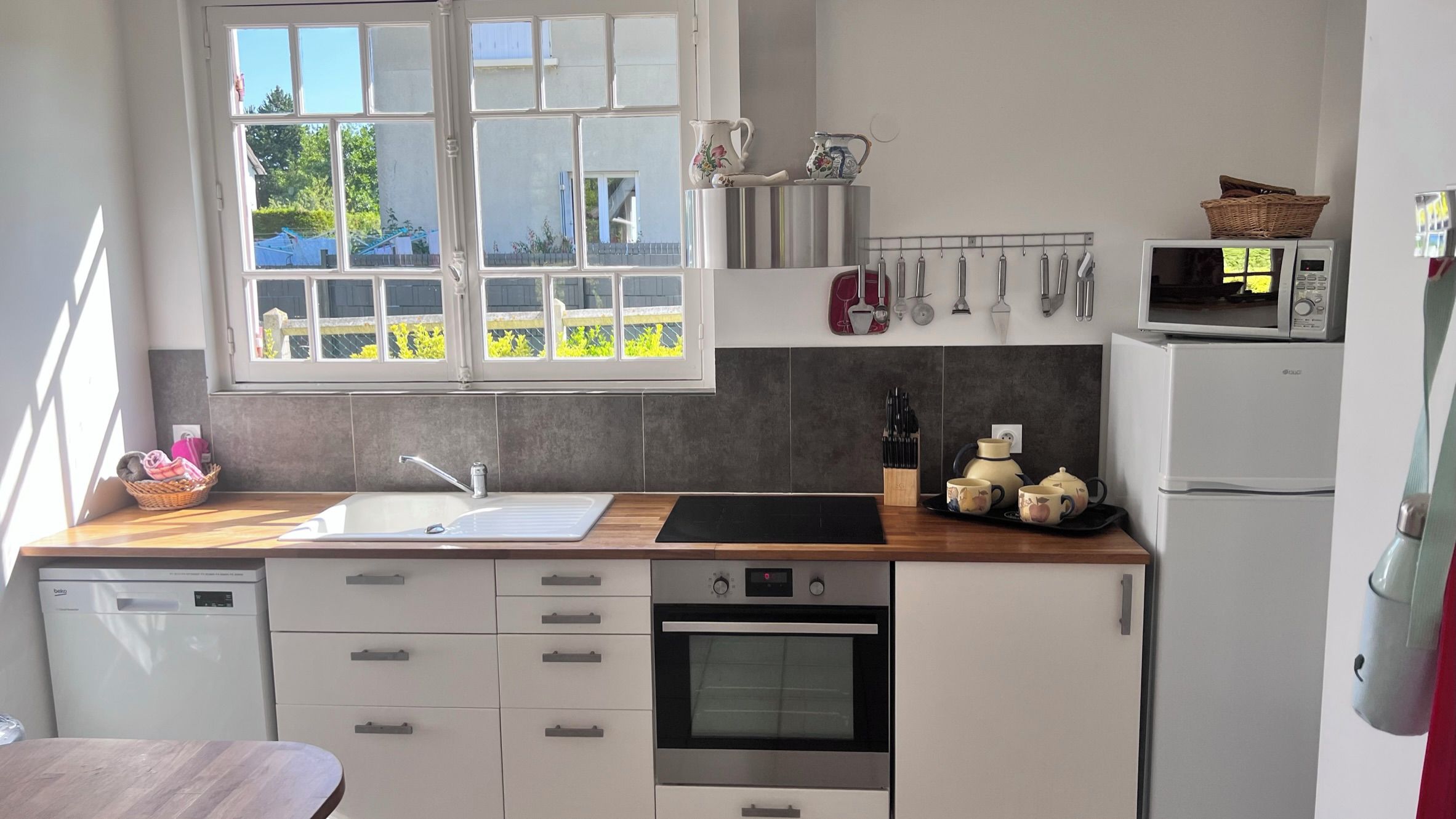 A modern kitchen with a built-in oven, a microwave, and a dishwasher.