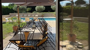 A patio with a pool table, chairs, and an umbrella. - 2 DUPLEX   1 STUDIO IN A WONDERFUL AND PEACEFUL PLACE (Maubec)