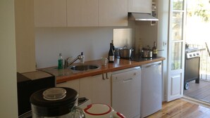 A compact kitchen with a sink, a dishwasher, and a stove. - Old Town of Lisbon, stunning 180º view of Castelo, 3-room apartment with terrace (Lisbonne)
