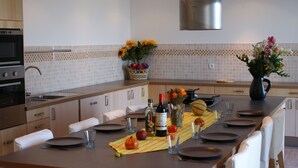 A modern kitchen with a dining area set for four.
