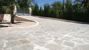 Stroll through the serene courtyard, surrounded by lush trees and a beautifully maintained stone pathway.
