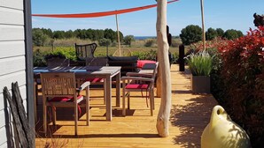 An outdoor patio with wooden furniture and a pergola.