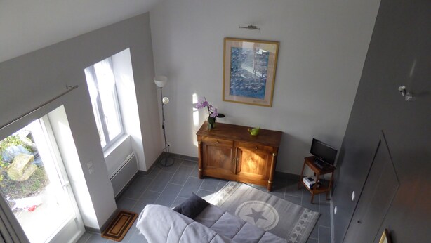 A bedroom with a bed, a dresser, a television, and a window. - Charming country house (Andonville)