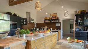 A modern kitchen with a central island, wooden cabinets, and a variety of appliances. - In the Mas des Pampres, Provence is at your fingertips (Cabannes)