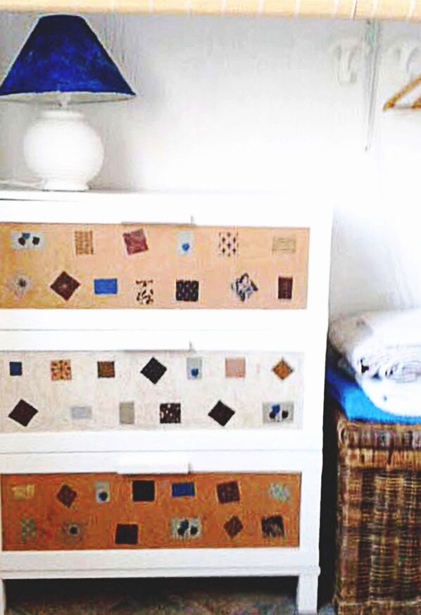 A white dresser with patterned drawers and a blue lampshade. - The old mill (Rapallo)