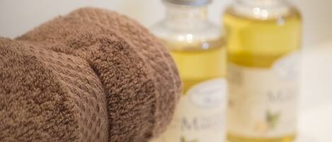 A close-up of a brown towel and two bottles of lotion.