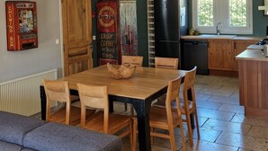 A compact kitchen with a dining area, wooden cabinets, and a refrigerator. - house in provence between Saint Remy and Avignon with swimming pool for 6 people (Graveson)