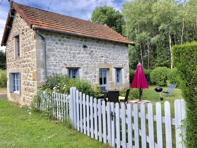 House made of regional stones, typical from Auvergne, greenery landscape
