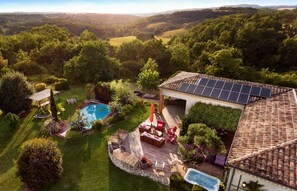 A heated pool, sun loungers