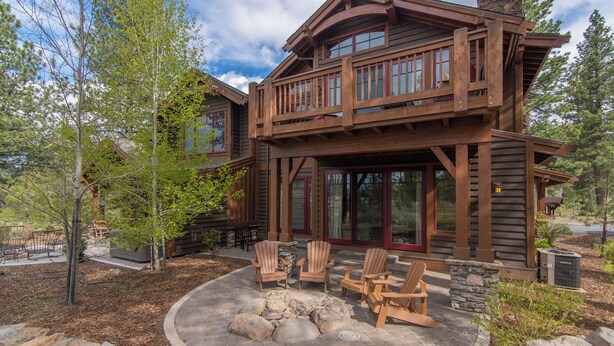 A wooden cabin with a stone foundation, a deck with Adirondack chairs, and a fire pit. - "Lovely Lookout" Ski, Golf & Club Amenities Schaffer's Mill, Lake Tahoe (Truckee)