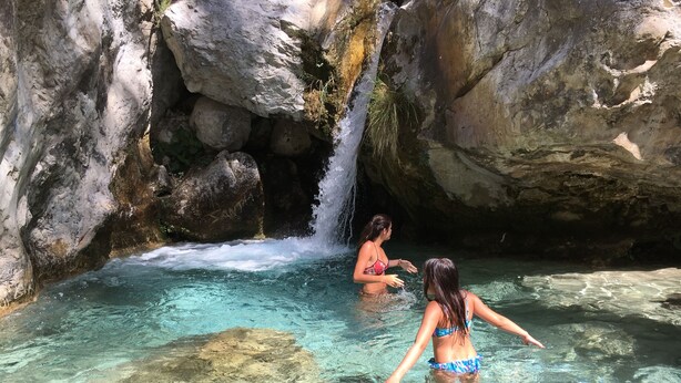 A natural pool with clear water and a waterfall, surrounded by rocky terrain. - Independent villa, magnificent sea view, private swimming pool, WIFI (ALGARROBO)