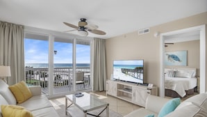 A hotel room with a balcony, a TV, a bed, and a view of the ocean. - 2BR Renovated Beachfront at Pelican, Stunning Ocean View, Pools Beach Chairs (Destin)