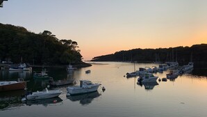 A marina with various boats docked, surrounded by trees and a calm water body. - 3 *** FEET IN THE WATER, FACING THE SEA, access to the Beach,  F3 BRETAGNE SUD (Clohars-Carnoët)