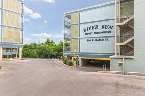 A building with a sign reading "River Run Resort Condominiums, 500 N. Market St." - Comal Riverfront Condo w/Pool, Longest Float, Tubes Included! (New Braunfels)
