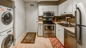 A compact kitchen with a washing machine, microwave, oven, and refrigerator. - Aug/Fall/Wntr LOW RATES & 3-Nite Min.! 5Star, 10/10 Clean, comfy, quiet, secure! (Hilton Head Island)