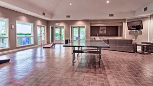 A spacious indoor area with a ping pong table, seating, and large windows. - Aug/Fall/Wntr LOW RATES & 3-Nite Min.! 5Star, 10/10 Clean, comfy, quiet, secure! (Hilton Head Island)