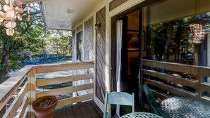 A wooden deck with a potted plant, a metal table, and a chair. - Aug/Fall/Wntr LOW RATES & 3-Nite Min.! 5Star, 10/10 Clean, comfy, quiet, secure! (Hilton Head Island)