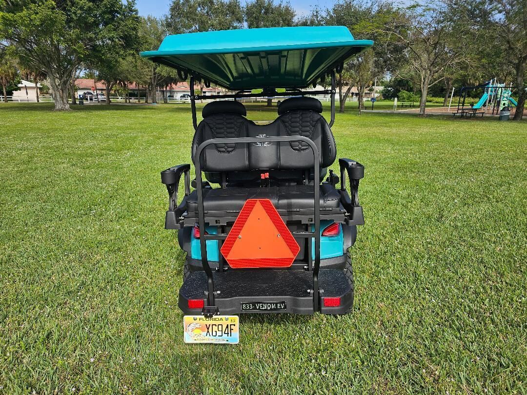 A golf cart with a blue canopy, a Florida license plate, and a red safety triangle.