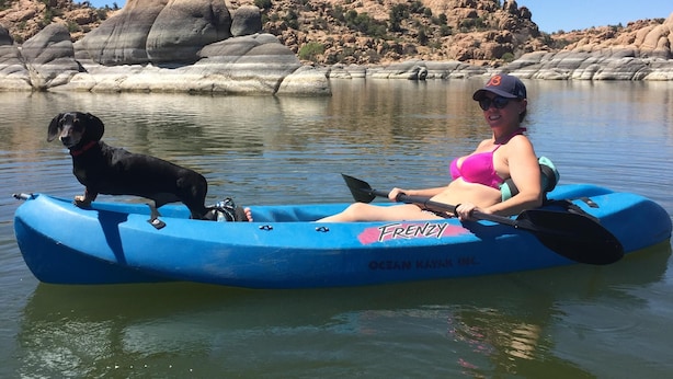 A person in a blue kayak with a dog on it, on calm water with rocky hills in the background. - Quaint Cabin With Spectacular Views Of The Granite Dells, Great Hiking/Kayaking! (Prescott)
