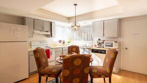 A modern kitchen with a dining table, chairs, and a microwave. -  Lake and Mountain Escape (Incline Village)
