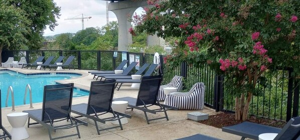 Relax by the serene pool surrounded by lush greenery and comfortable seating areas.