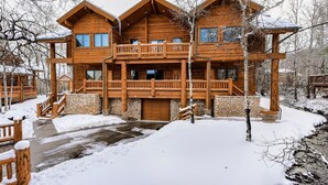A multi-story log cabin with a stone foundation, wooden balconies, and a stone staircase leading to the entrance. - Luxury Ski or Hiking retreat- 2 KING beds and more! (Park City)