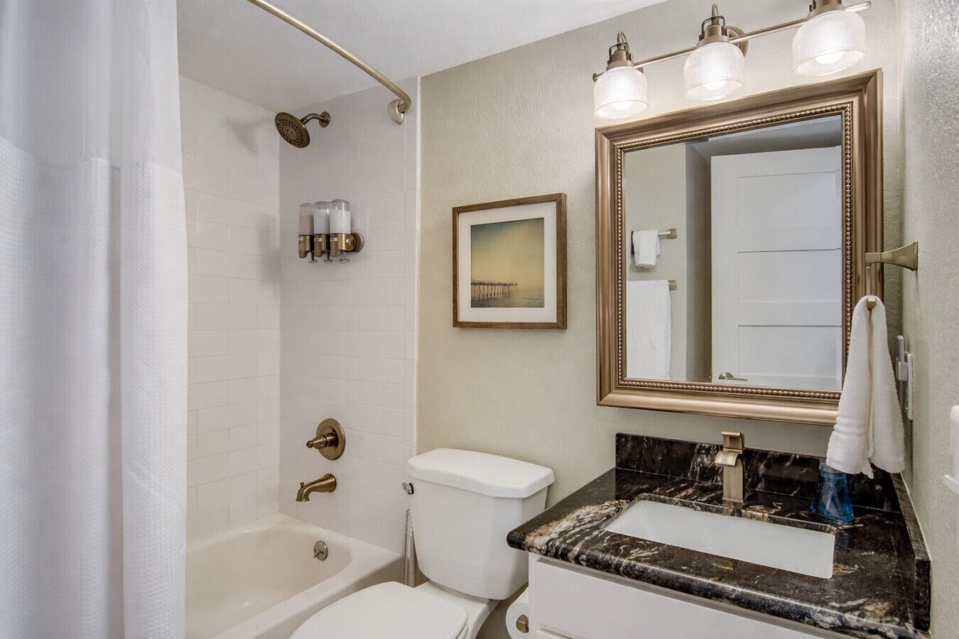 Fresh, bright bathroom with a tub/shower—easy for family-friendly stays and quick rinses after the Galveston Island beach.