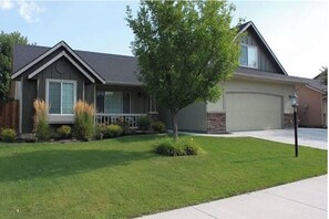 A residential house with a front yard, a driveway, and a garage.