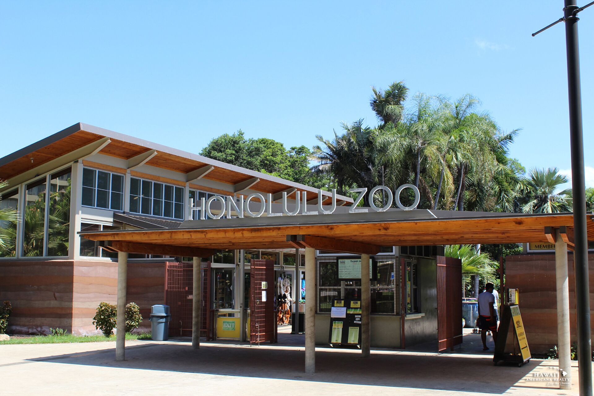 The exterior of Honolulu Zoo with a modern design, featuring large windows and a covered entrance area.