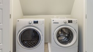 A laundry room with two front-loading washing machines.