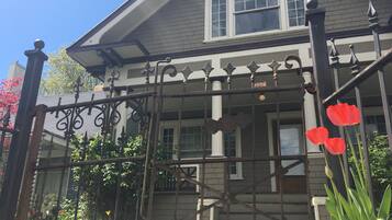 Traditional home with a central entrance, surrounded by a well-maintained garden and vibrant flowers.