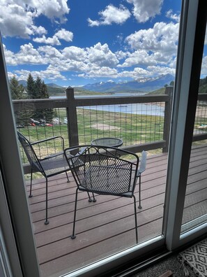 A deck with metal chairs and a table, overlooking a lake and mountains. - Breathtaking Views In Serene Setting, Close To It All (Dillon)