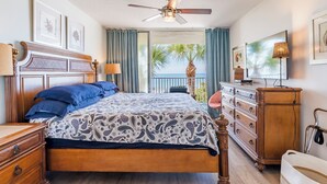 A bedroom with a bed, dresser, and a ceiling fan. - WAKE UP TO THIS AMAZING VIEW - Large Balcony - New Kitchen & Bathroom (Indian Rocks Beach)