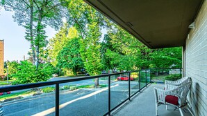 A balcony with a view of a street and trees. - the Lanai, Best Area, Large Balcony, WD, Condo (Tacoma)