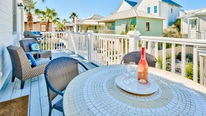 A covered outdoor area with a round table, chairs, and a grill. - Gulf Front Pool + Bikes! South of 30A, Steps to Beach, between Alys & Rosemary (Seacrest Beach)