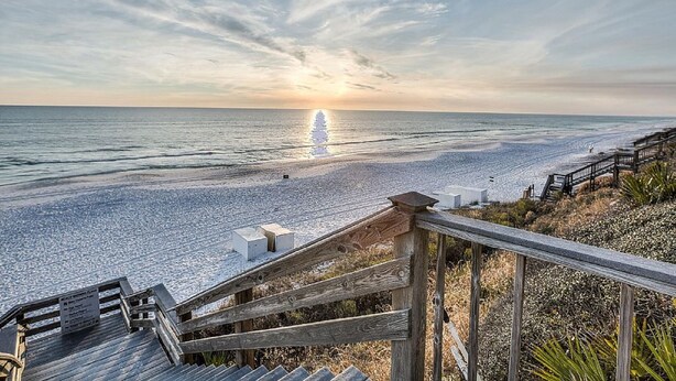 A wooden staircase leading to a beach with a clear sky and the sun setting over the ocean. - Gulf Front Pool + Bikes! South of 30A, Steps to Beach, between Alys & Rosemary (Seacrest Beach)